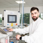 Photo of lab worker at extrusion machine console, Galway city Ireland Ridgeback Technologies industrial process photography